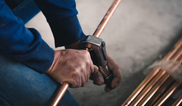 Plumber working with copper pipe